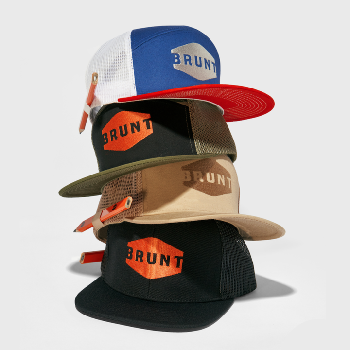 Four stacked flat brim work hat with built in pencil holder and BRUNT logo in red, white and blue, army green camo, black and khaki