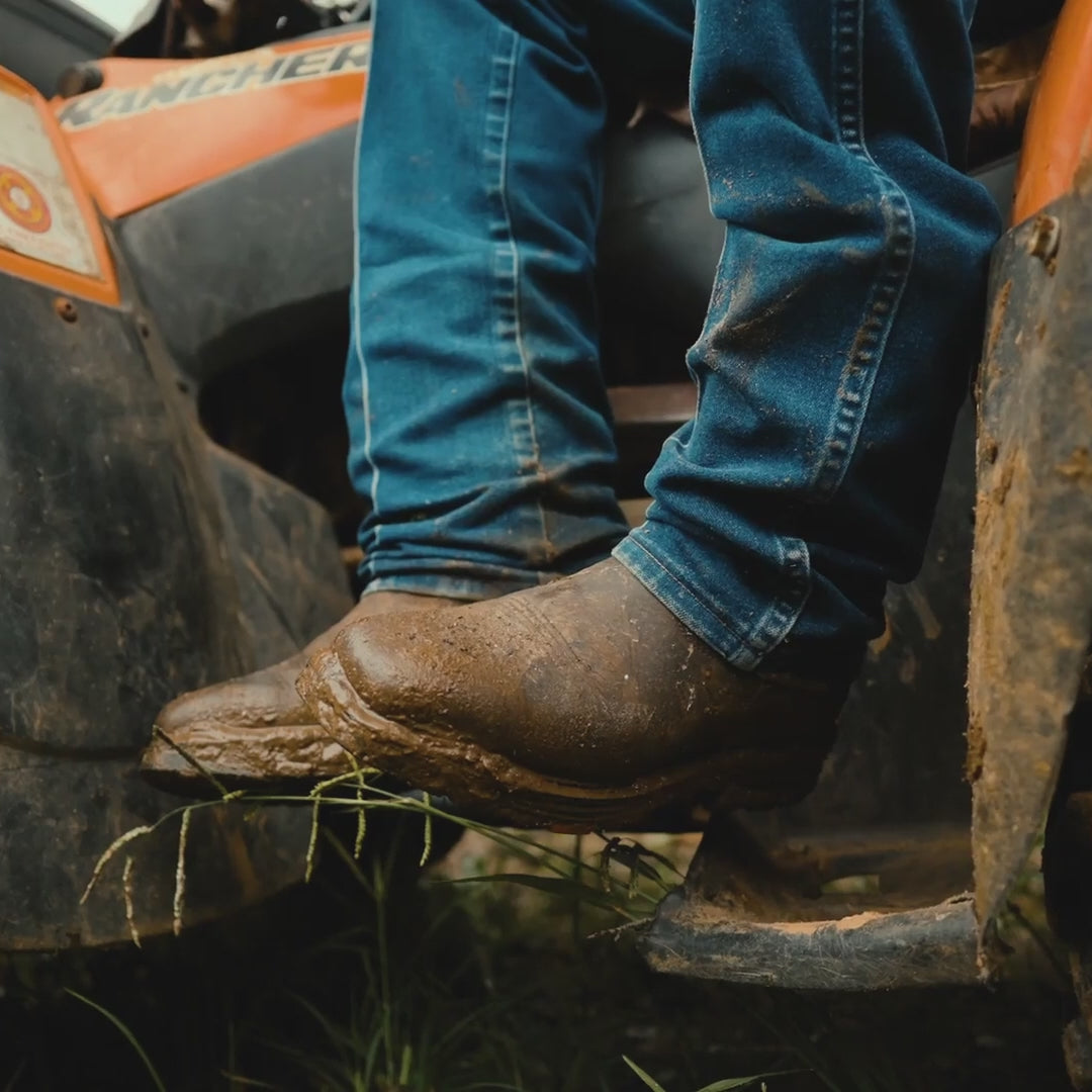 video of man wearing BRUNT BRUNT 10 inch welted waterproof composite square toe work boot in dark brown working on farm